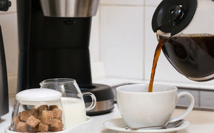 Pouring drip brew coffee into a mug